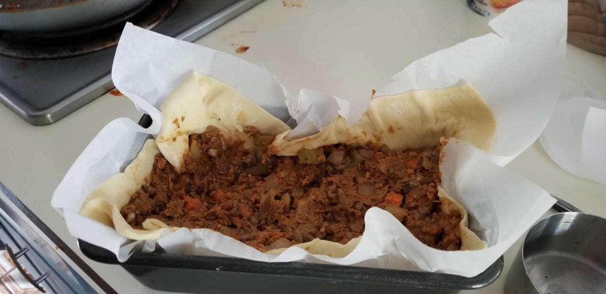 Stuff the lentil and walnut filling into the vegan puff pastry to make vegan walnut wellington topless pie