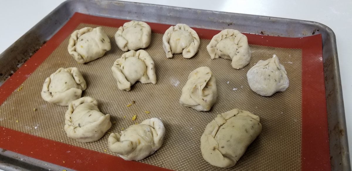 vegan dumplings sitting on a baking sheet